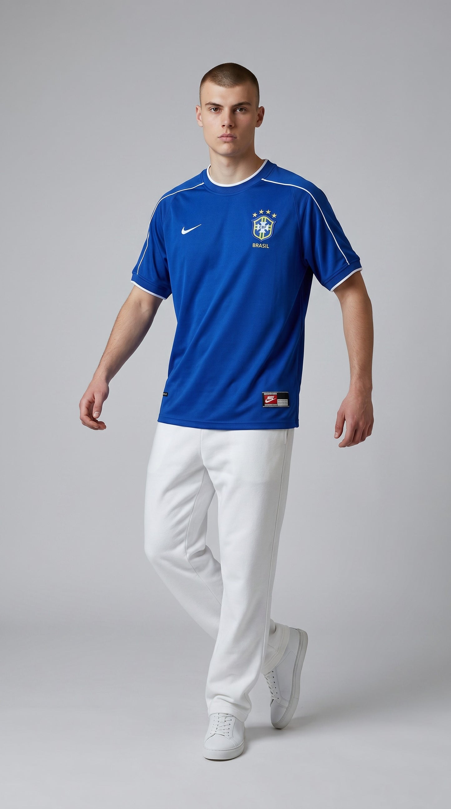 Model wearing a blue My Store 8 Brazil 1998 away soccer jersey with white trim and team crest on a grey background.