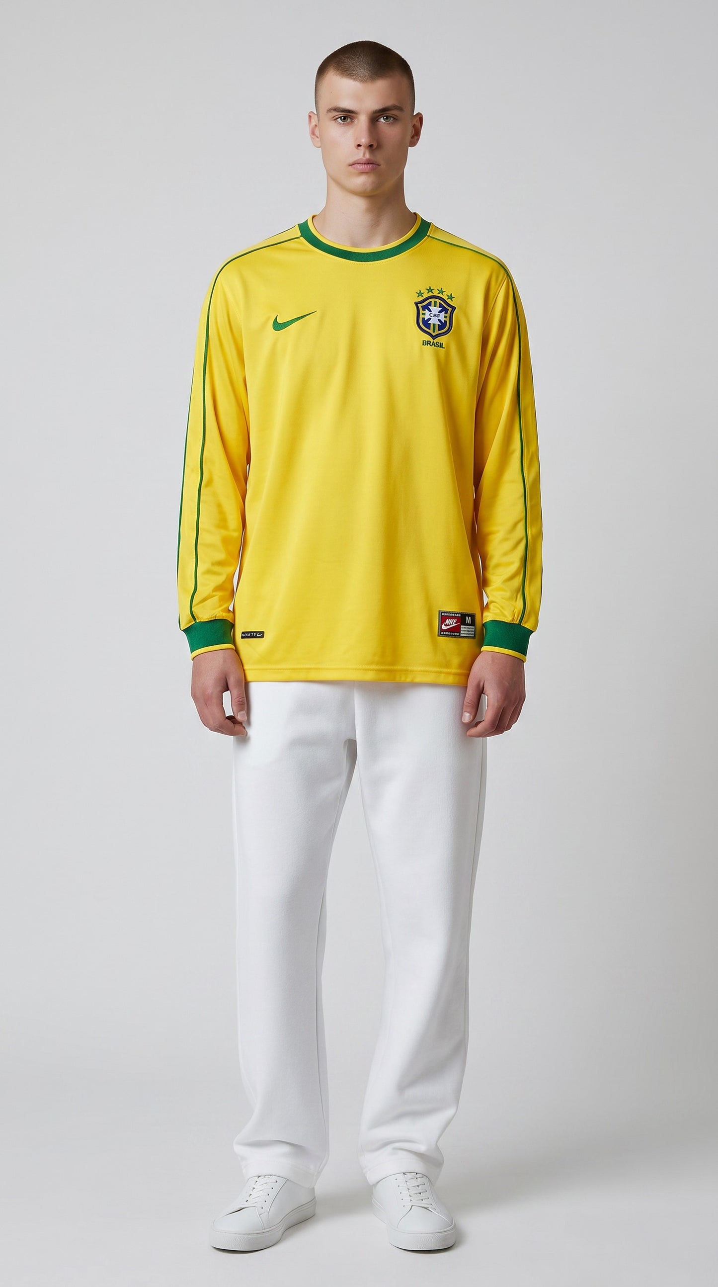 My Store 8 yellow long-sleeve Brazil 1998 home soccer jersey with green trim on a male model wearing white pants.