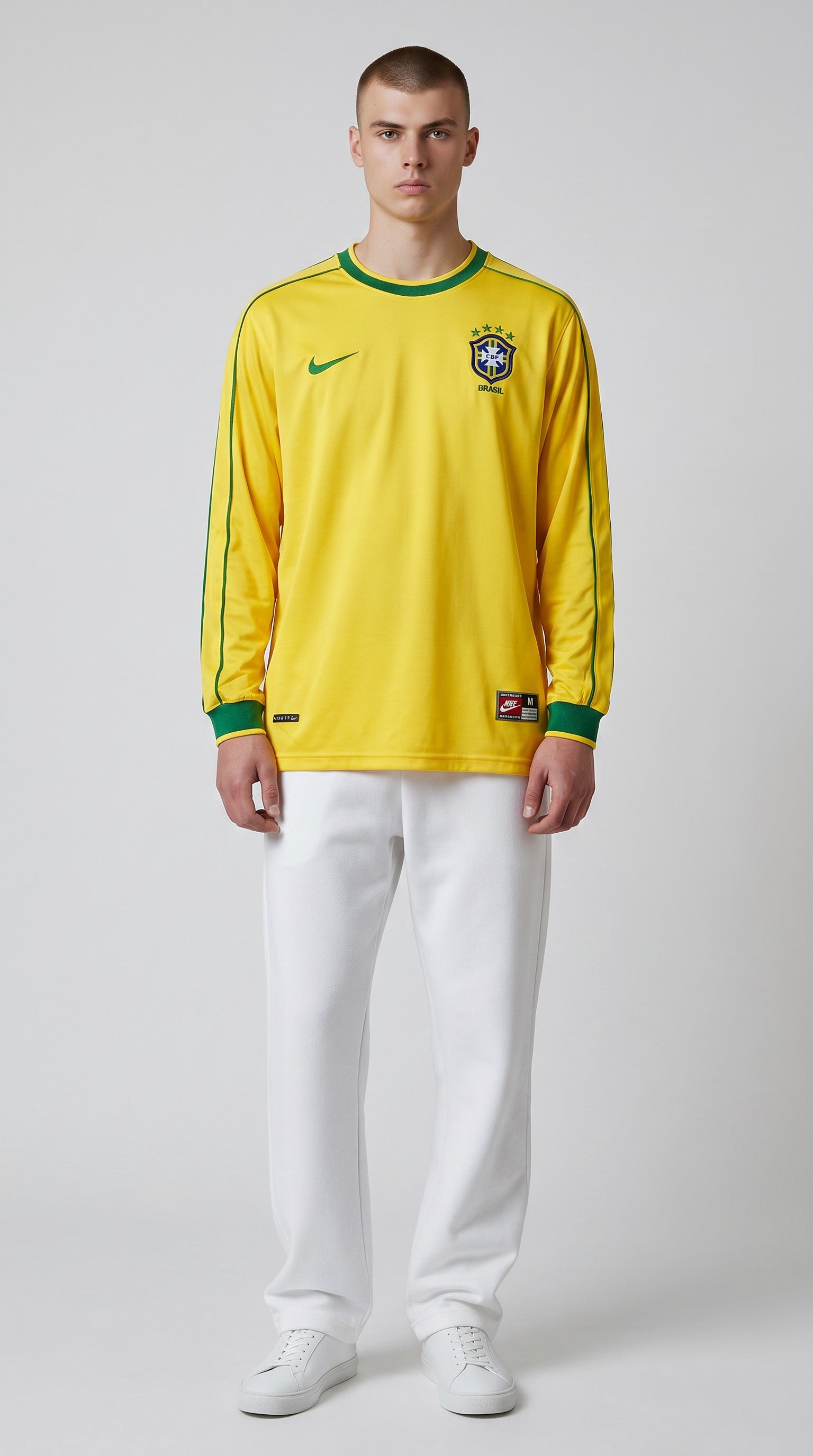 My Store 8 yellow long-sleeve Brazil 1998 home soccer jersey with green trim on a male model wearing white pants.